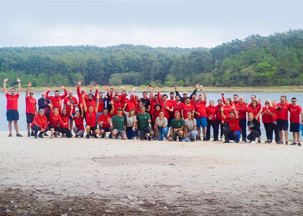The Anturio team gathered outdoors, by a lagoon